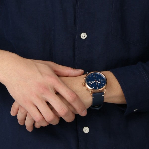 Fossil Commuter FS5404 chronograph watch worn on wrist with navy leather strap