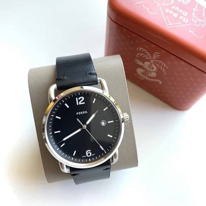 Fossil Commuter watch displayed on stand with Fossil retail box in background