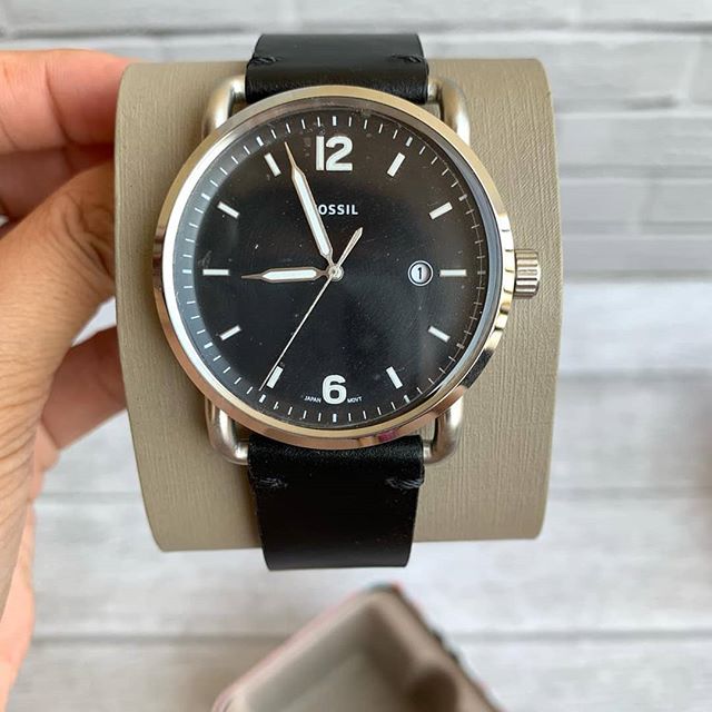 Fossil Commuter watch worn on wrist with black leather strap visible