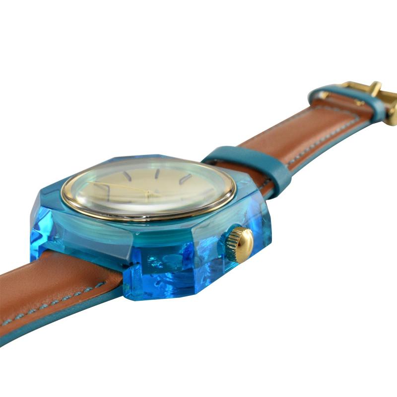 Side view of Fossil ES3536 watch with turquoise case and brown leather band