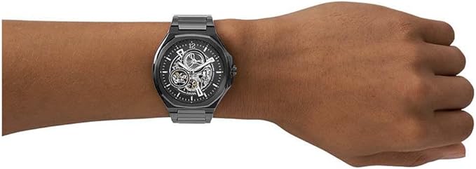 Fossil Evanston automatic watch worn on wrist with black stainless steel case and skeleton dial