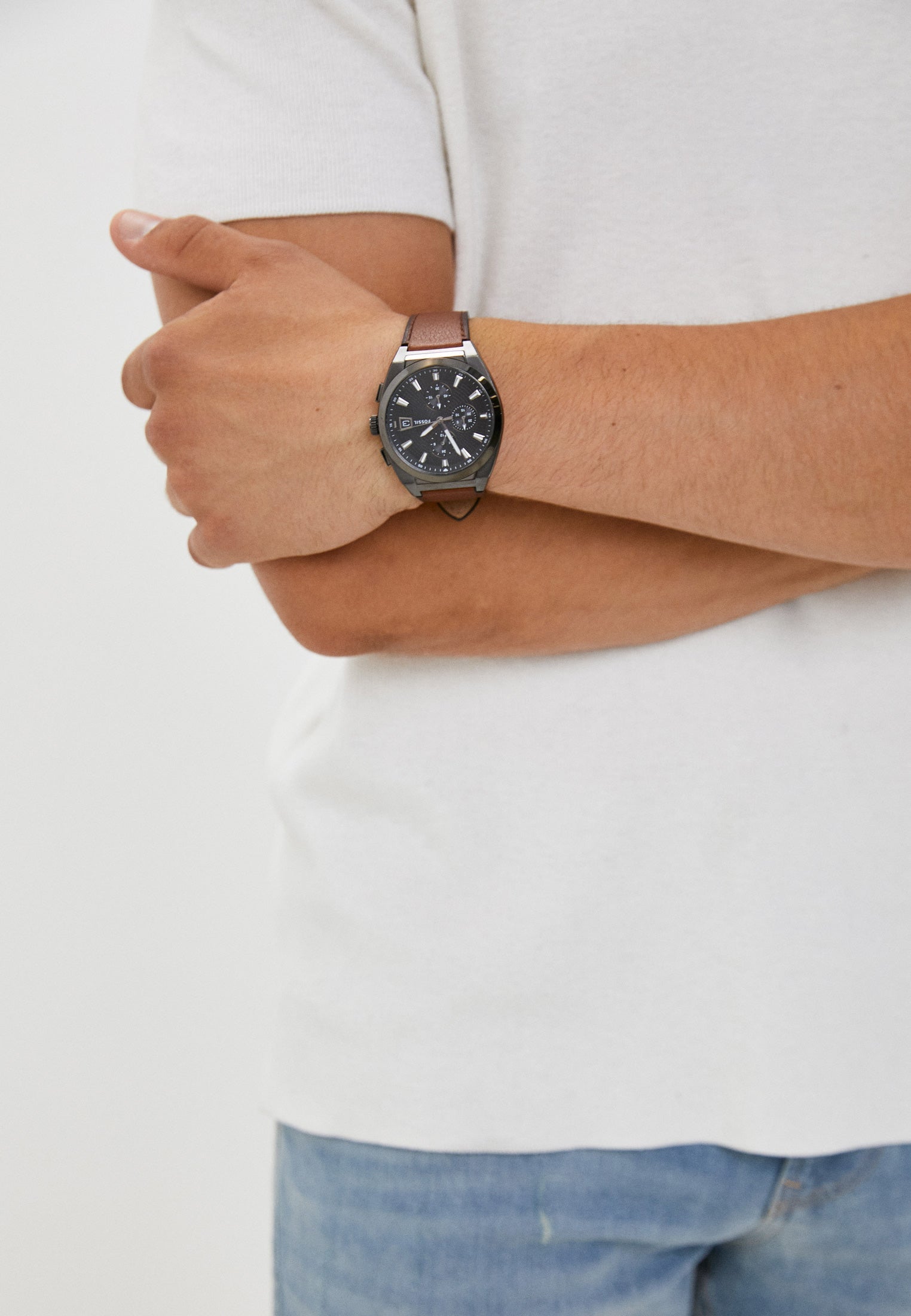 Fossil Everett chronograph watch worn on wrist with grey dial and cognac leather strap