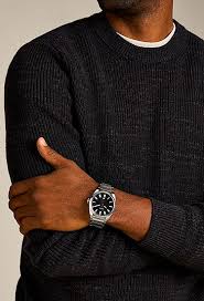 Fossil Everett watch worn on wrist with stainless steel bracelet