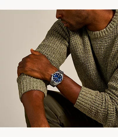 Fossil Everett watch worn on wrist with stainless steel bracelet