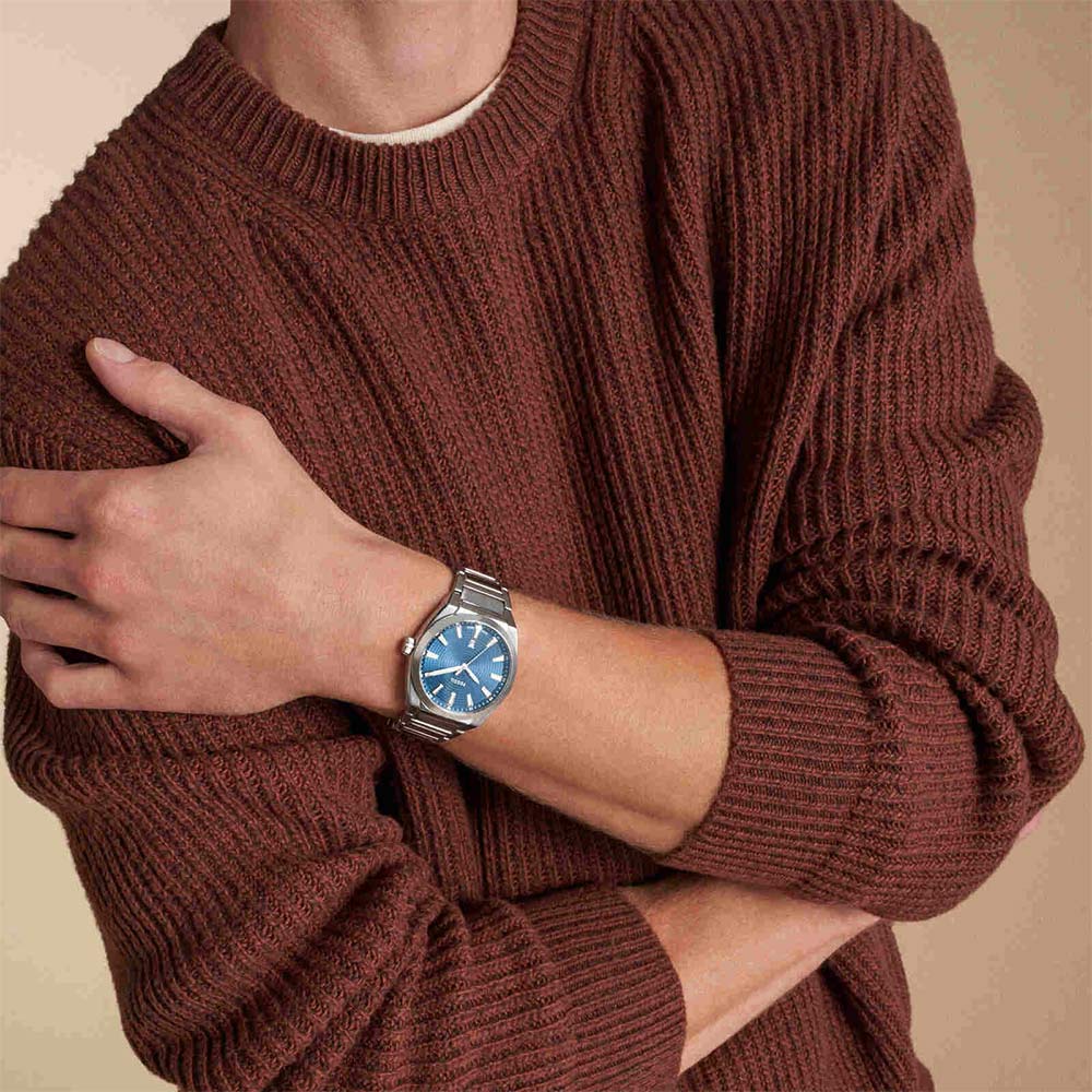 Fossil Everett FS6054 watch worn on wrist with blue dial and stainless steel bracelet