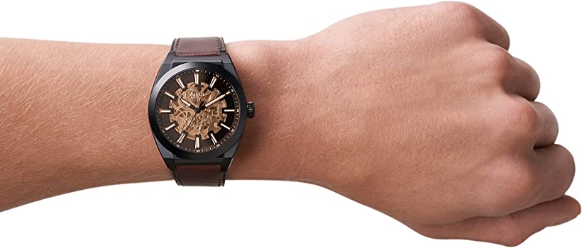 Fossil Everett automatic watch worn on wrist showing skeleton dial and brown leather strap