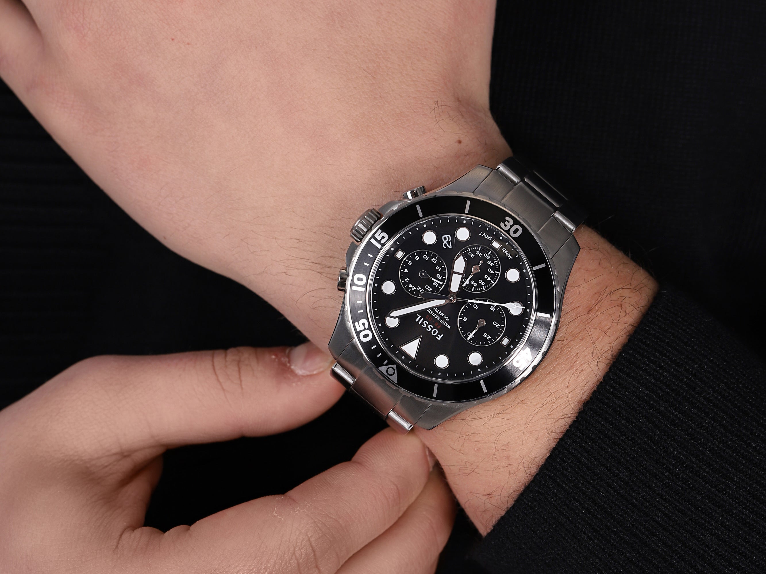 Fossil FB-03 chronograph watch on wrist with black dial and stainless steel band