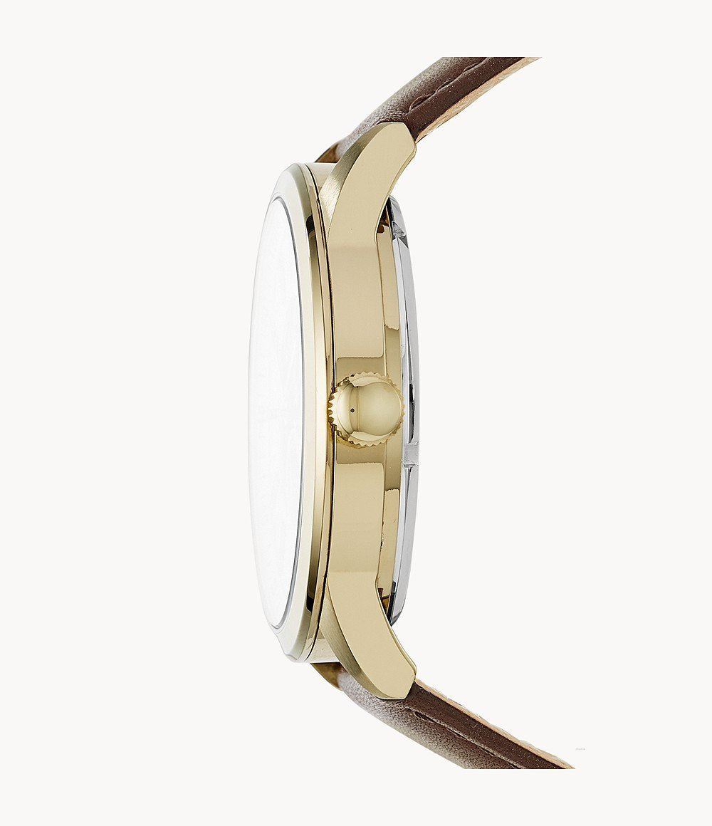 Side view of Fossil Flynn watch showing gold-tone case, crown, and brown leather strap