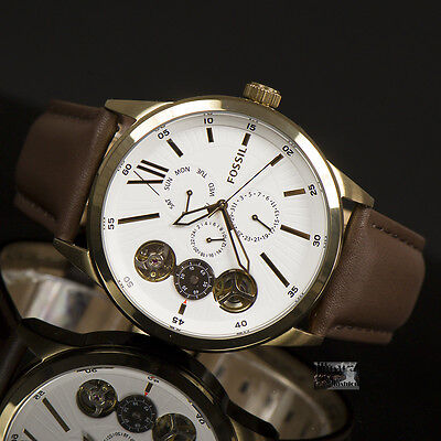 Fossil Flynn watch on wrist displaying white dial with open heart mechanical subdials