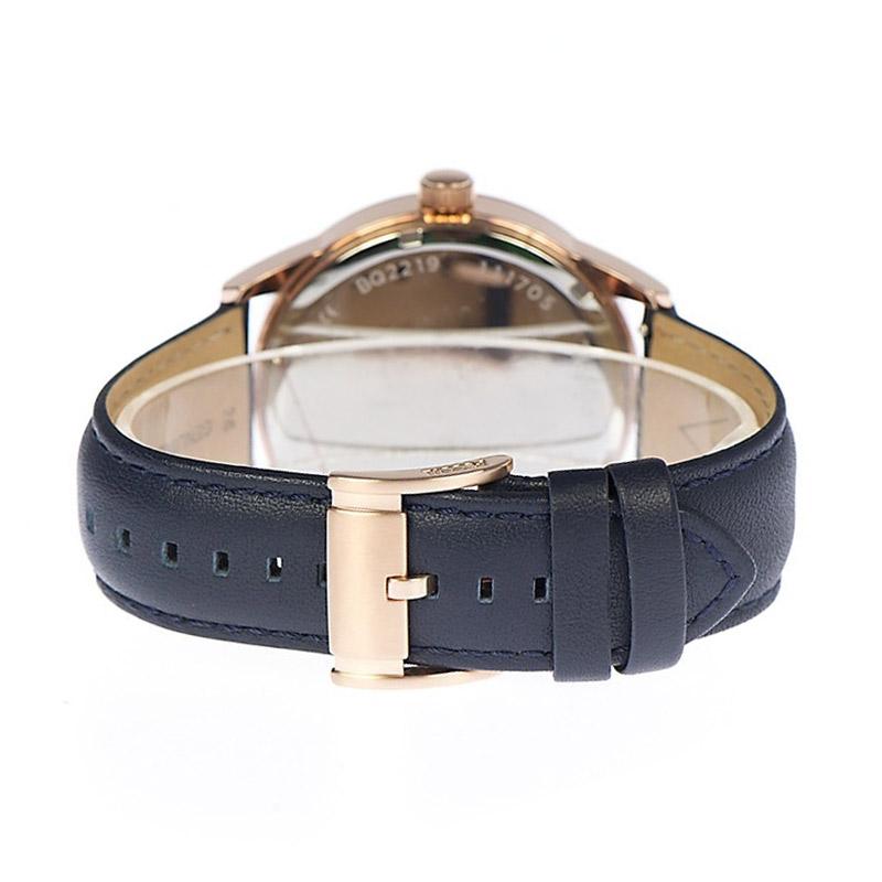 Caseback view of Fossil Flynn mechanical watch showing rose gold case and navy leather strap clasp