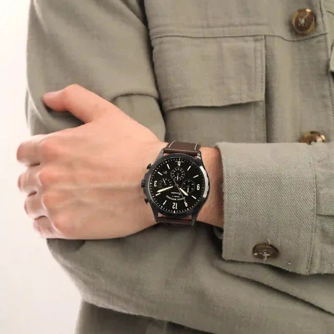 Fossil Forrester chronograph watch worn on wrist with black dial, rose gold hands, and brown leather strap