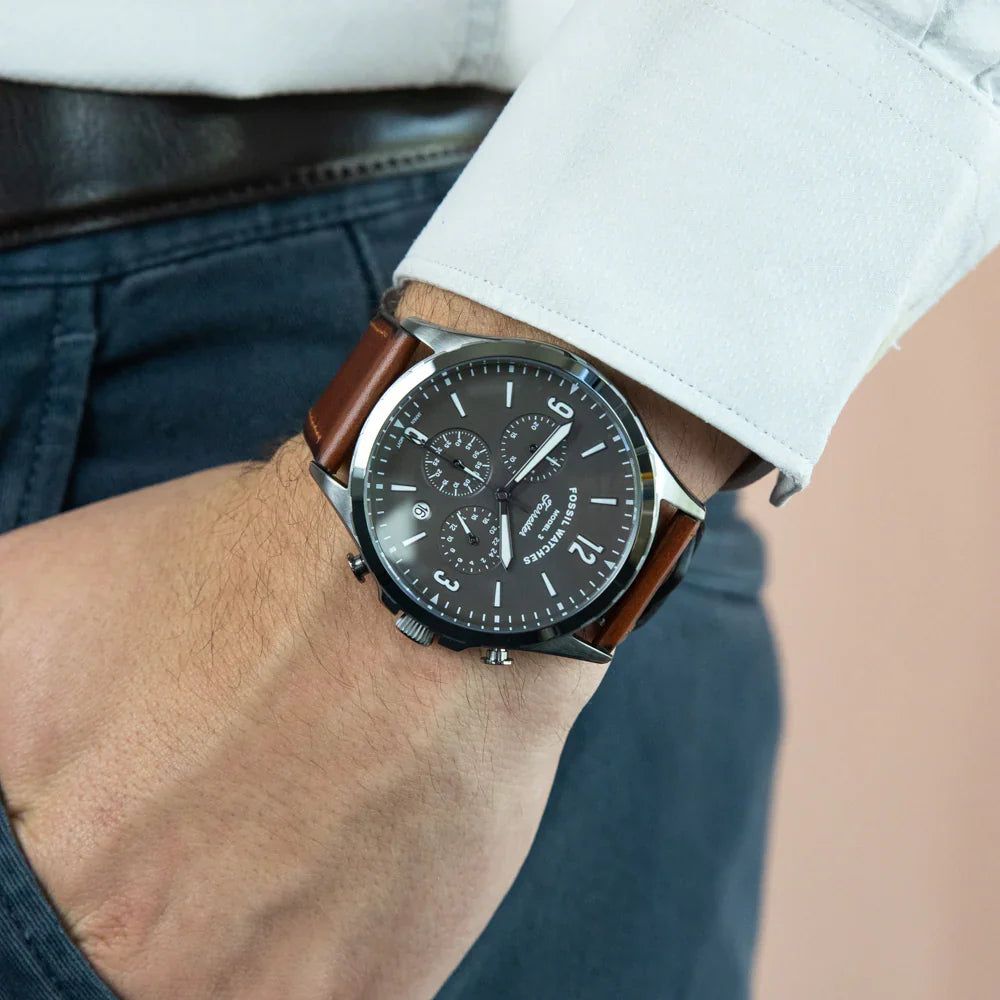 Fossil Forrester chronograph watch worn on wrist with grey dial and brown leather strap