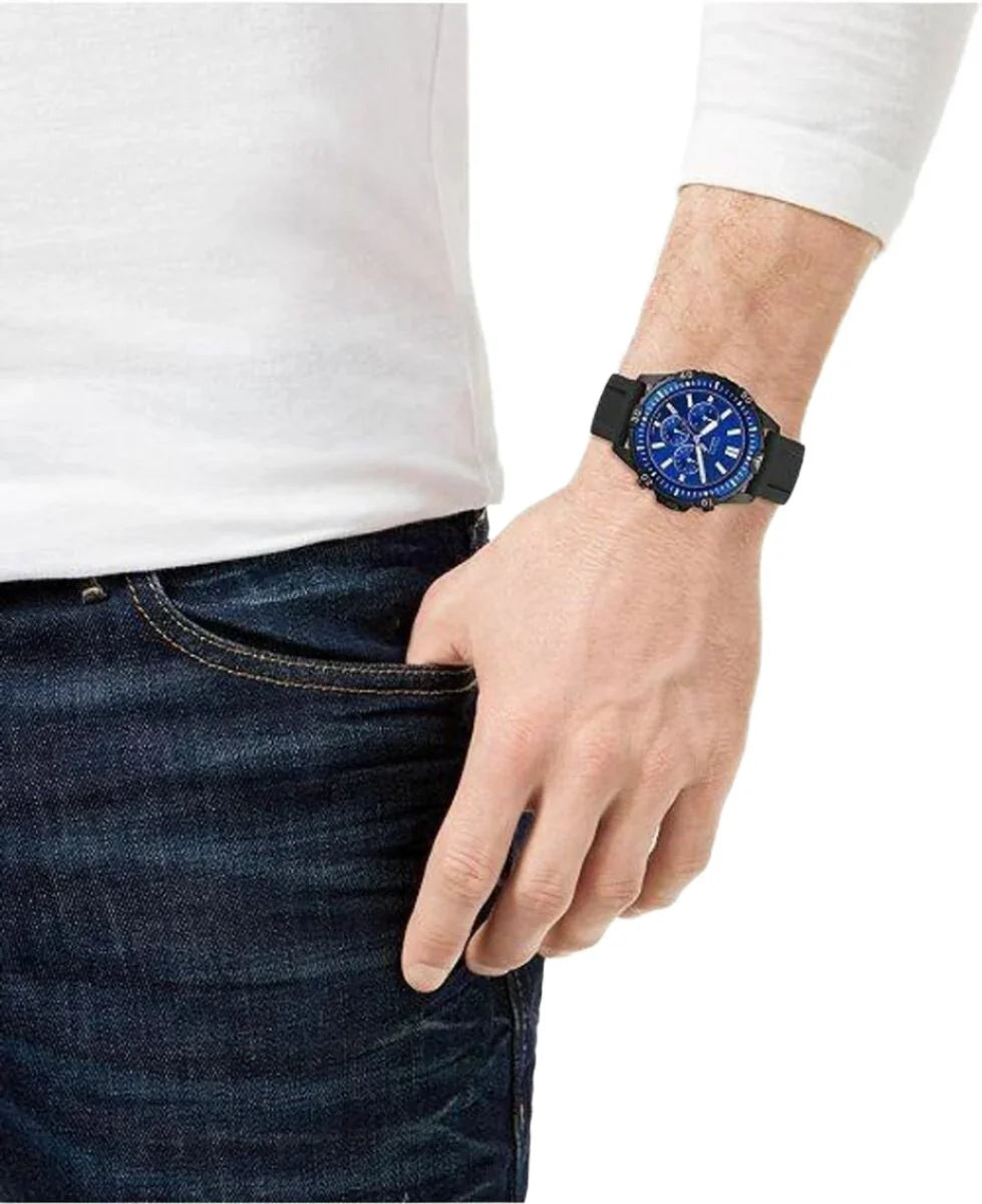 Fossil Garrett Chronograph watch worn on wrist, blue dial visible with black silicone strap