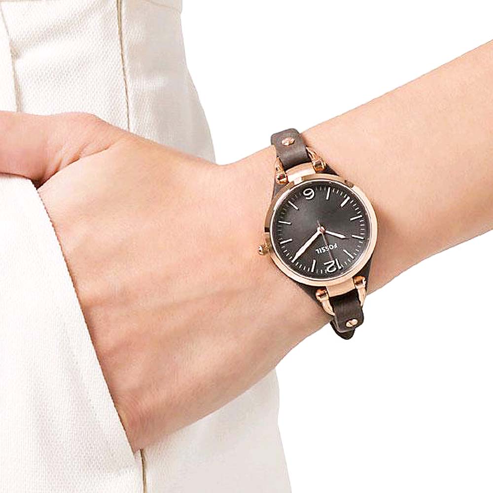 Fossil Georgia watch worn on wrist showing grey dial and black leather band with studs