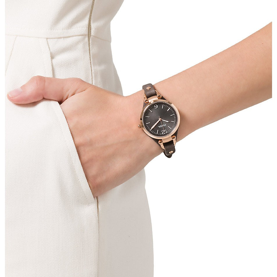 Fossil Georgia ladies watch worn on wrist with gold-tone case and black leather strap