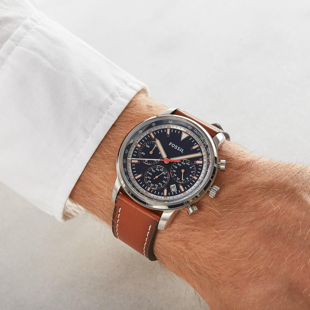 Fossil Goodwin chronograph watch worn on wrist with light brown leather strap