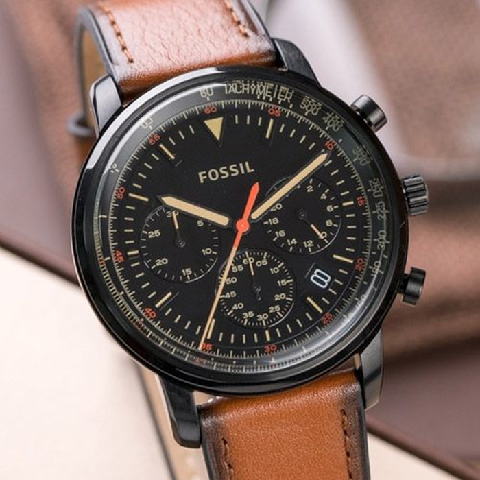 Close-up of Fossil Goodwin chronograph dial with black face, gold hands, red second hand