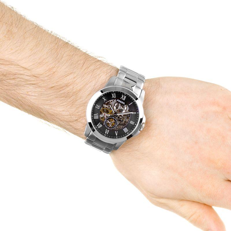 Fossil Grant automatic watch worn on wrist showing black dial and skeleton design
