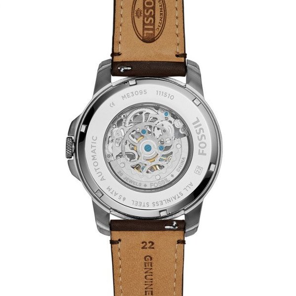 Fossil Grant caseback with visible automatic movement and engraved text on transparent display case