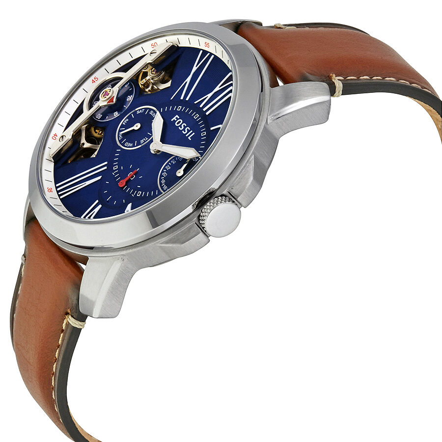 Fossil Grant chronograph watch angled view showing dial, visible movement, and brown leather band