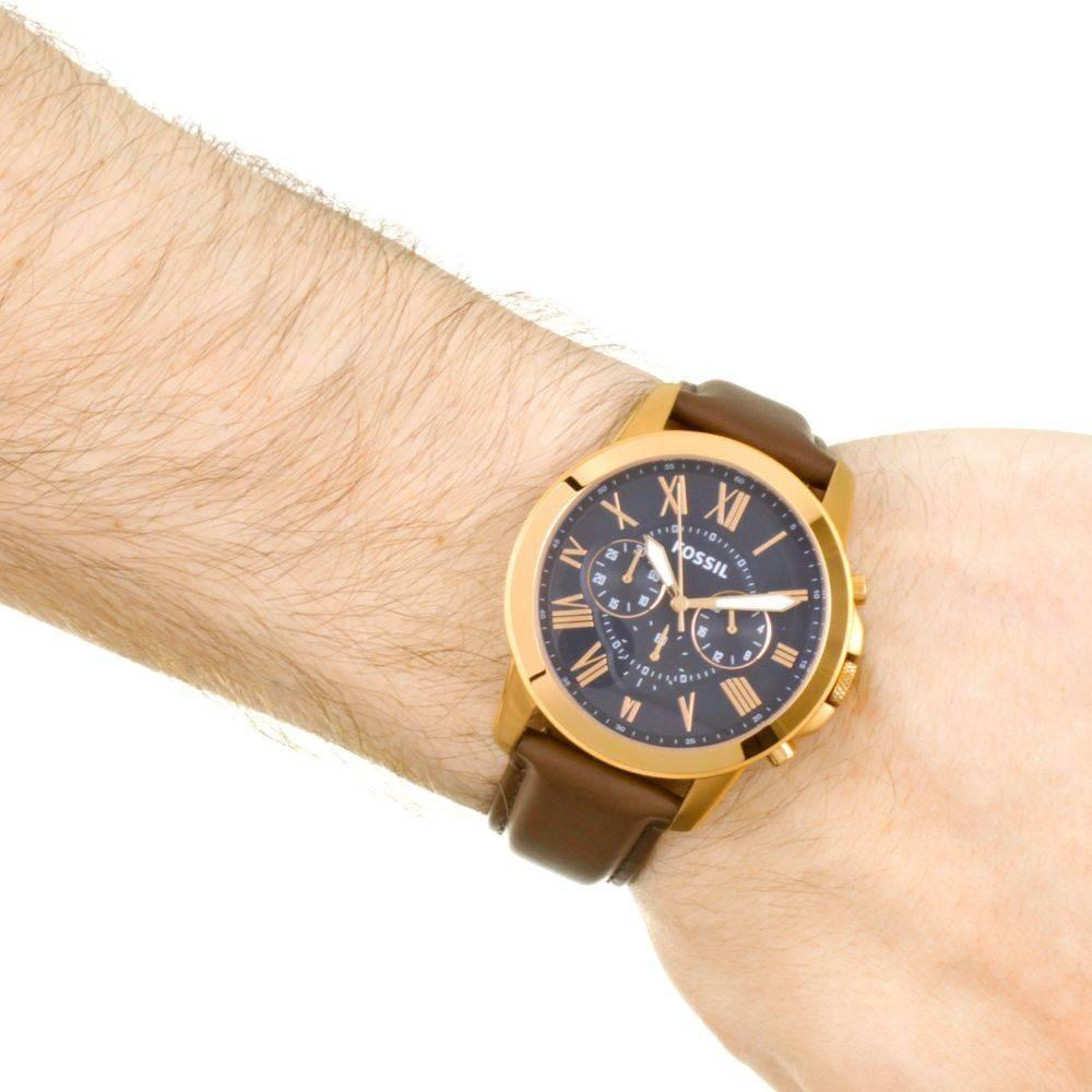 Fossil Grant FS5068 chronograph watch worn on wrist with blue dial and brown leather strap