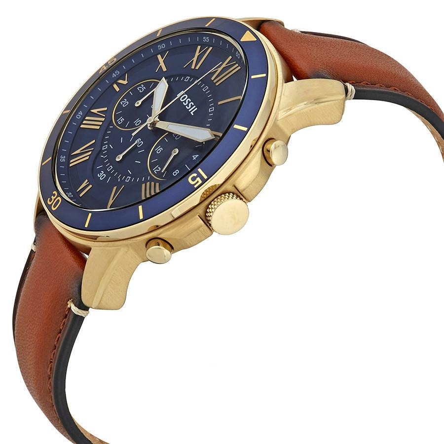 Fossil Grant chronograph watch angled view showing gold case, blue dial with roman numerals, and brown leather strap