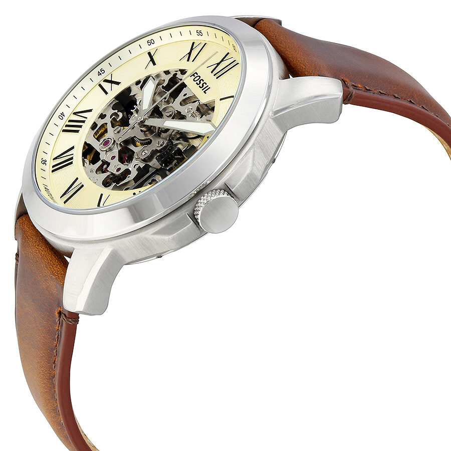 Angled side view of Fossil Grant watch showing skeleton dial mechanism and brown leather strap