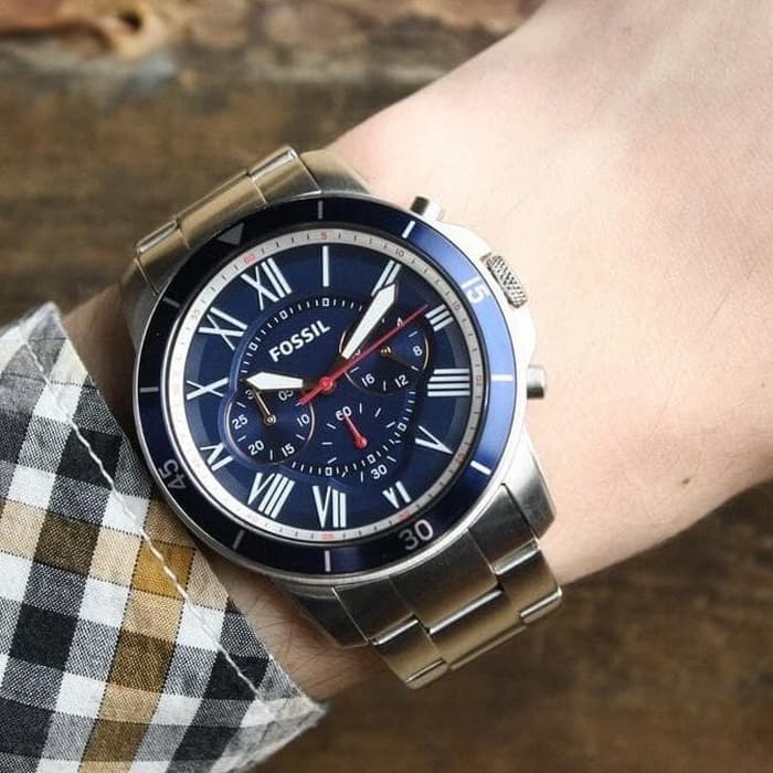 Fossil Grant Sport chronograph watch worn on wrist, blue dial with stainless steel bracelet