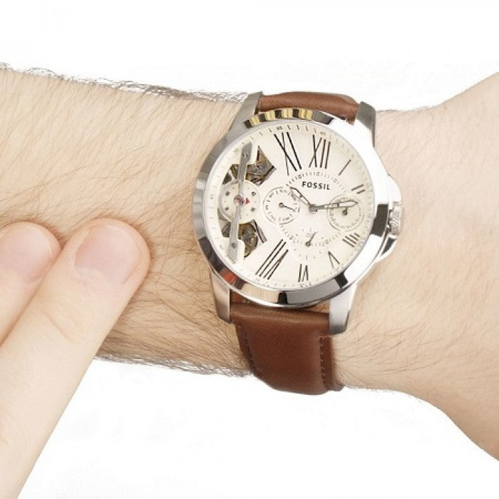 Fossil Grant Twist watch worn on wrist with beige dial and brown leather band