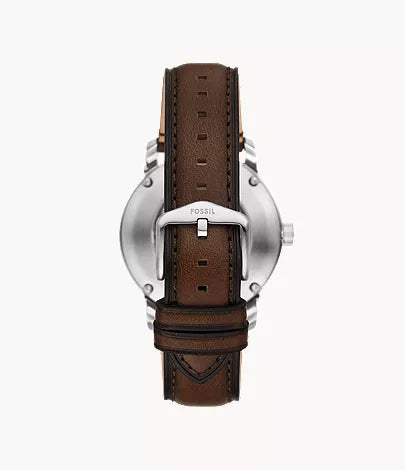 Caseback view of Fossil Heritage Automatic showing silver-tone case and brown leather strap