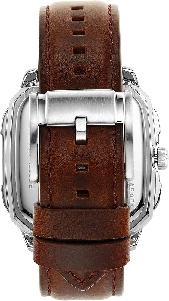 Fossil Inscription skeleton watch worn on wrist, showcasing blue dial and brown leather band