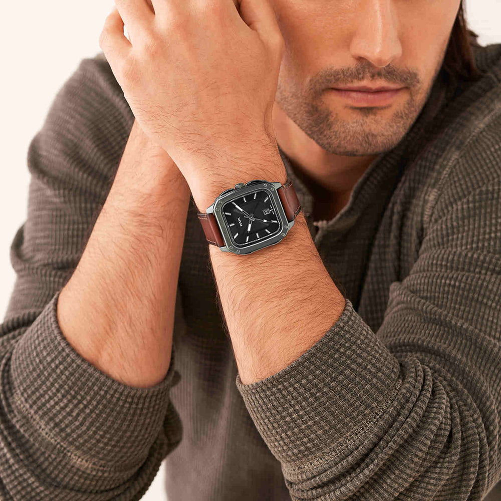 Fossil Inscription FS5934 worn on male wrist, black dial with square gunmetal case and amber leather