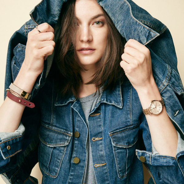 Fossil Jacqueline rose gold watch worn on wrist with denim jacket