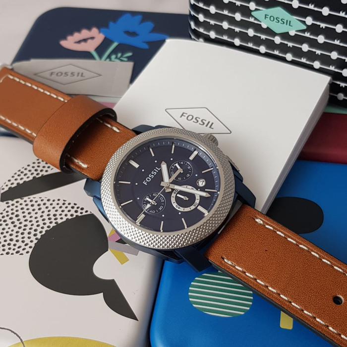 Fossil Machine watch with tan leather strap displayed with branded box and accessories