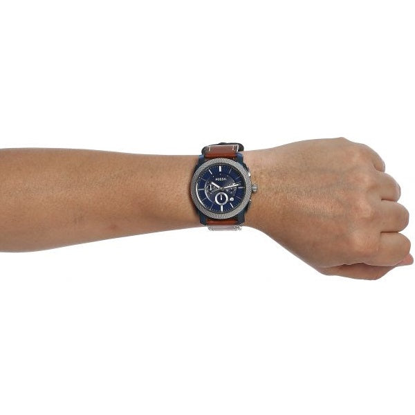 Fossil Machine chronograph watch with blue dial worn on wrist