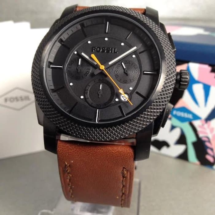 Fossil Machine chronograph dial detail showing black face with orange hands and subdials
