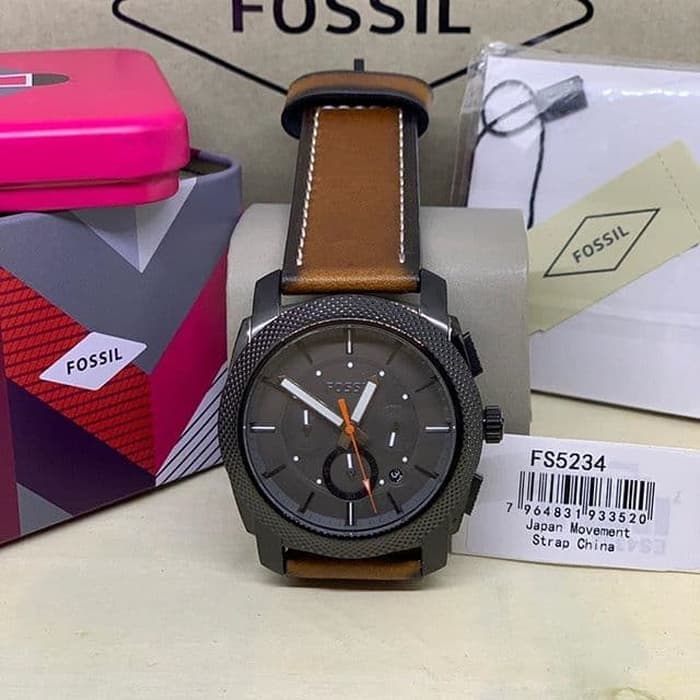 Fossil Machine chronograph watch worn on wrist with black dial and brown leather strap