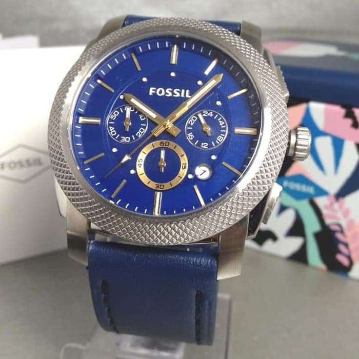 Fossil Machine chronograph watch worn on wrist displaying blue dial with yellow accents and navy strap