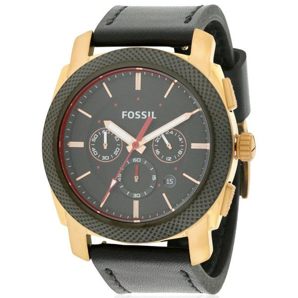 Angled view of Fossil Machine chronograph showing gold-tone case and black dial with subdials