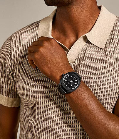 Fossil Machine black watch worn on wrist with cream colored shirt
