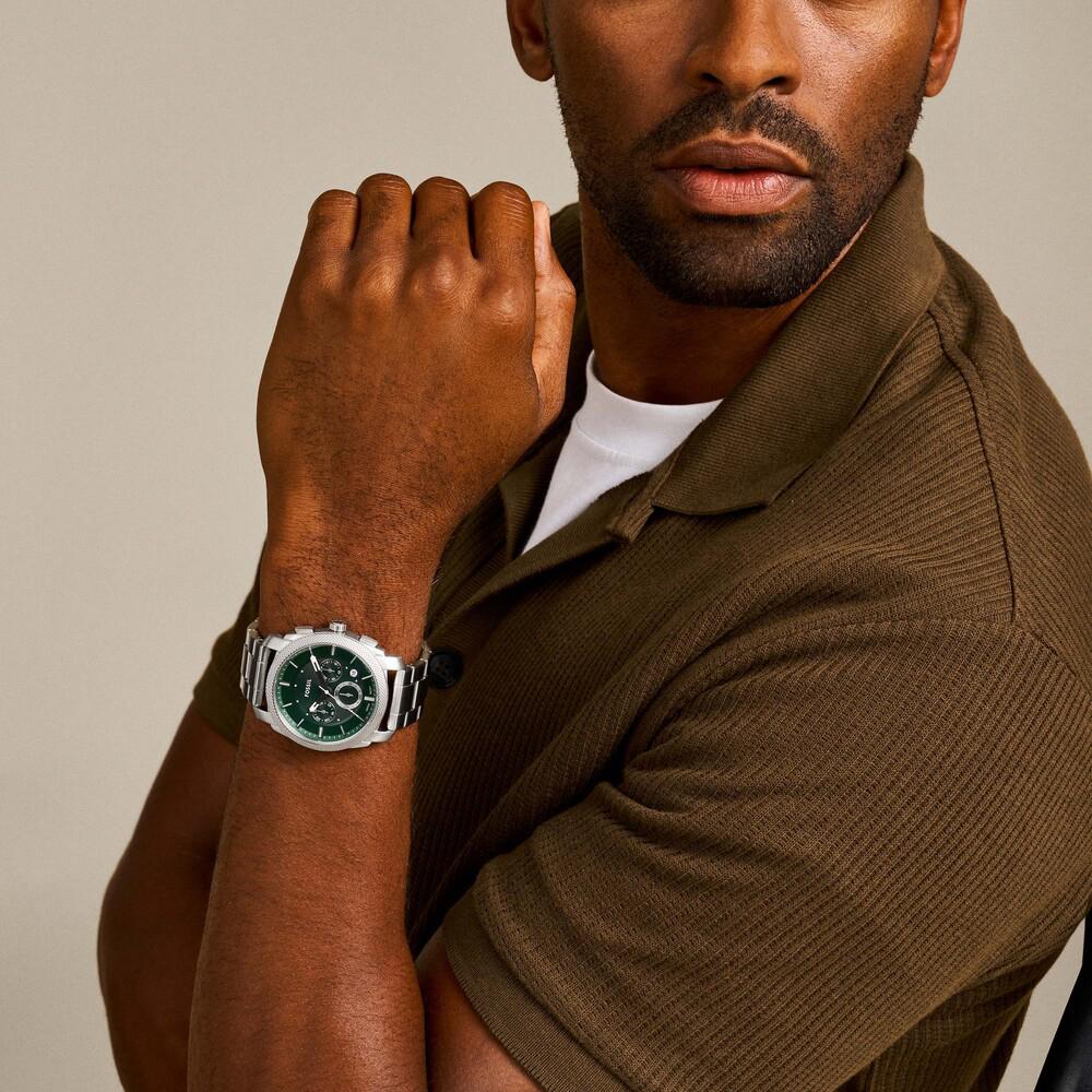 Fossil Machine FS6079 chronograph watch worn on wrist, green dial visible with stainless steel bracelet
