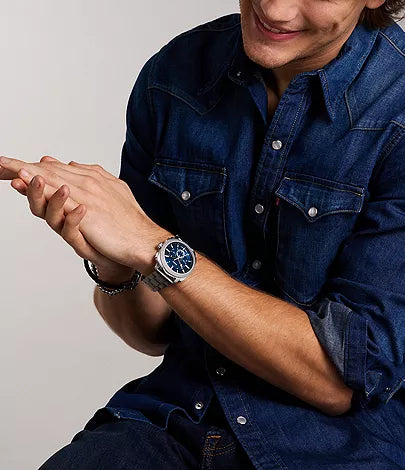 Fossil Machine Chronograph watch worn on wrist with blue dial visible
