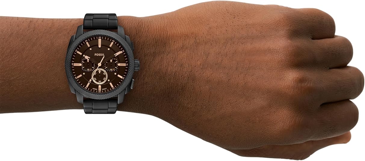 Fossil Machine Chronograph worn on wrist showing brown dial with gold accents and black steel bracelet