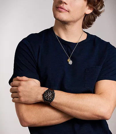 Fossil Machine Chronograph watch worn on wrist showing black dial and brown leather strap