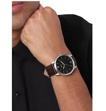 Fossil Minimalist FS5464 watch worn on wrist with black dial and brown leather strap