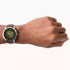 Fossil Minimalist FS5464 watch worn on wrist with green dial visible