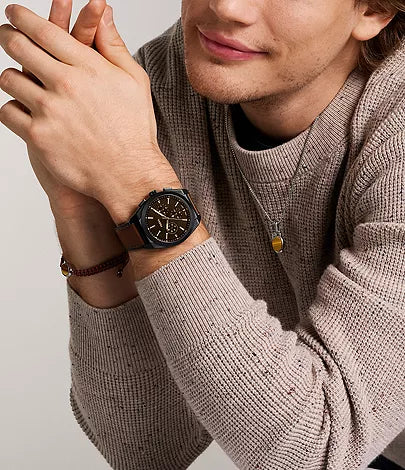 Fossil Minimalist watch worn on wrist, showing black case and brown leather strap on model