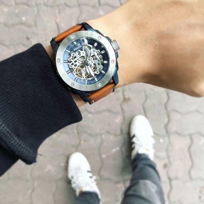 Fossil ME3135 automatic watch on wrist with skeleton dial and brown leather strap