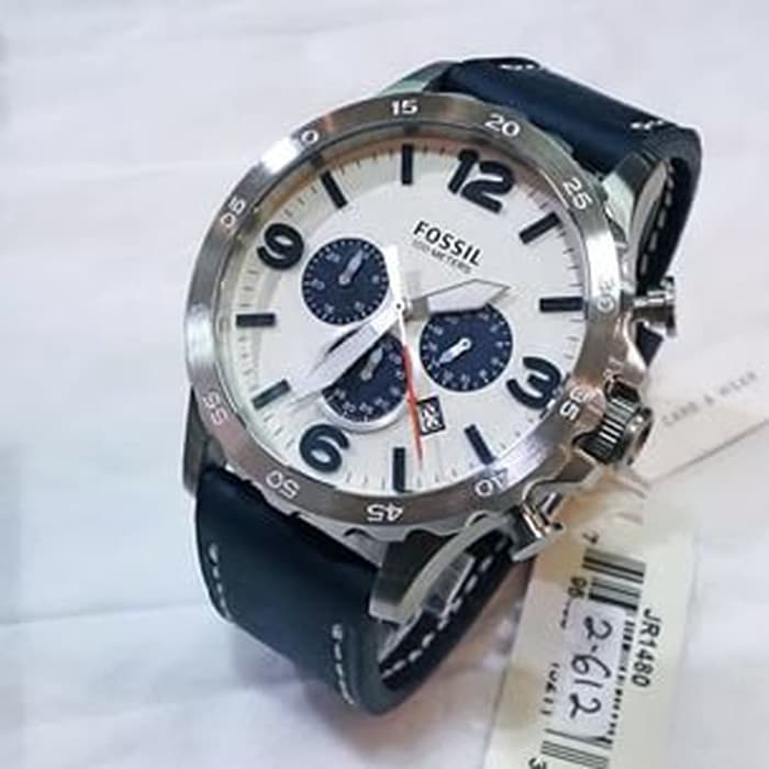 Fossil Nate chronograph watch worn on wrist showing beige dial and blue leather strap