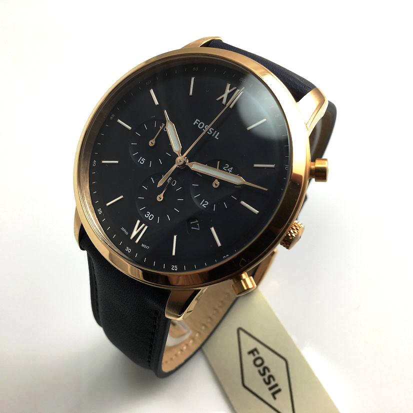 Angled view of Fossil Neutra Chronograph watch with gold case and navy leather band